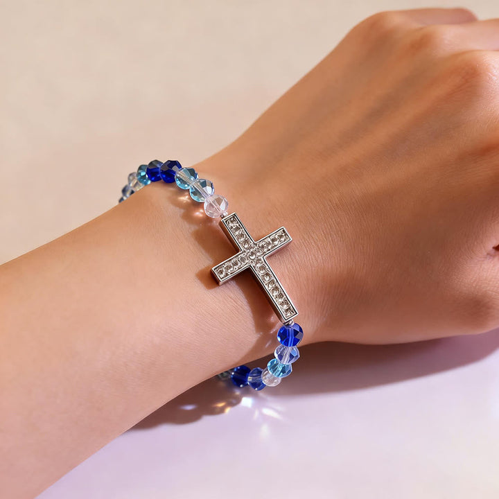 Shimmering White and Blue Peacock Cross Bracelet: A Symbol of Faith