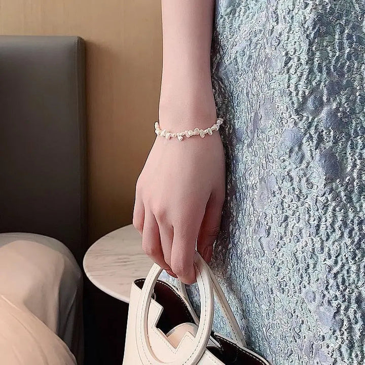 Céline Pearl Bracelet" can be rewritten as "Céline Pearl Charm Bracelet.