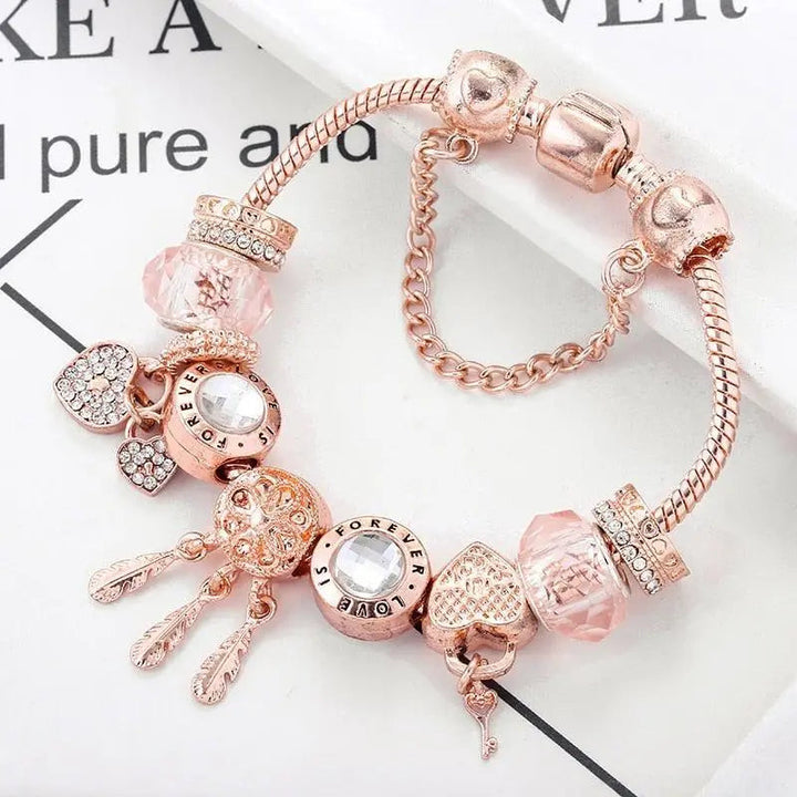 Pink Dream Catcher Bracelet with Silver Charms" can be rewritten as:

"Charming Pink Dream Catcher Bracelet with Silver Accents