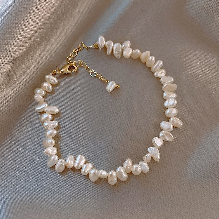 Céline Pearl Bracelet" can be rewritten as "Céline Pearl Charm Bracelet.