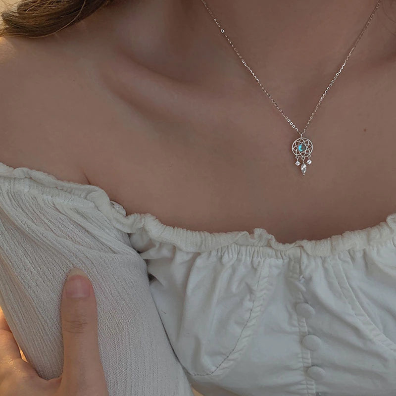 Silver Moon Crystal Dreamcatcher Necklace" can be rewritten as "Silver Dreamcatcher Necklace with Moon Crystal.