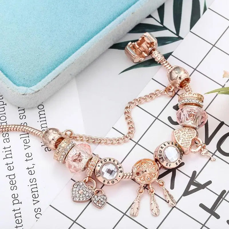 Pink Dream Catcher Bracelet with Silver Charms" can be rewritten as:

"Charming Pink Dream Catcher Bracelet with Silver Accents