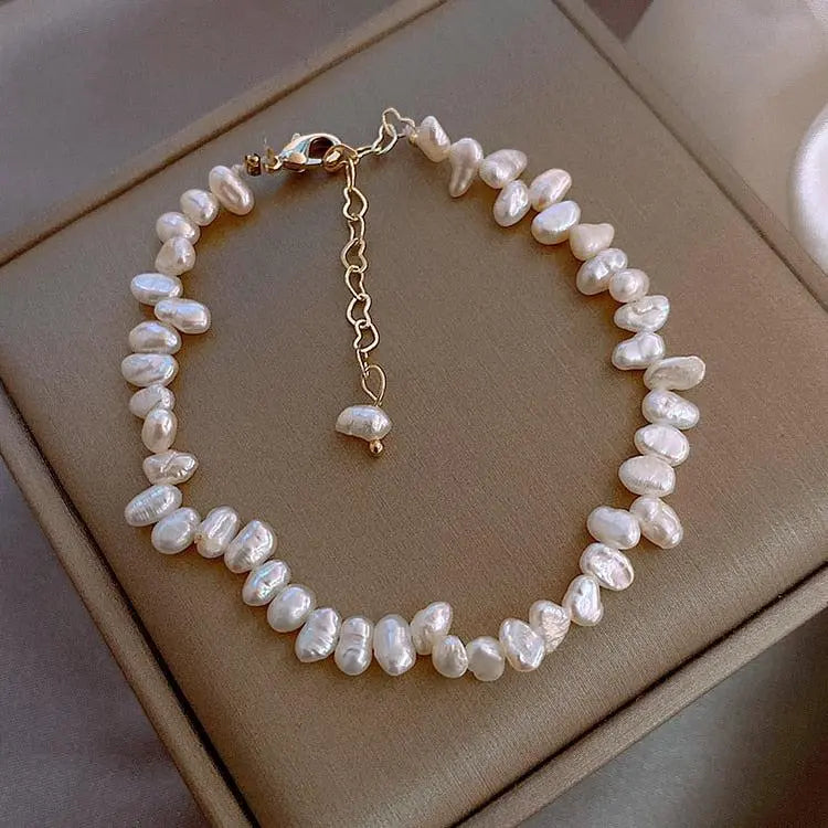 Céline Pearl Bracelet" can be rewritten as "Céline Pearl Charm Bracelet.