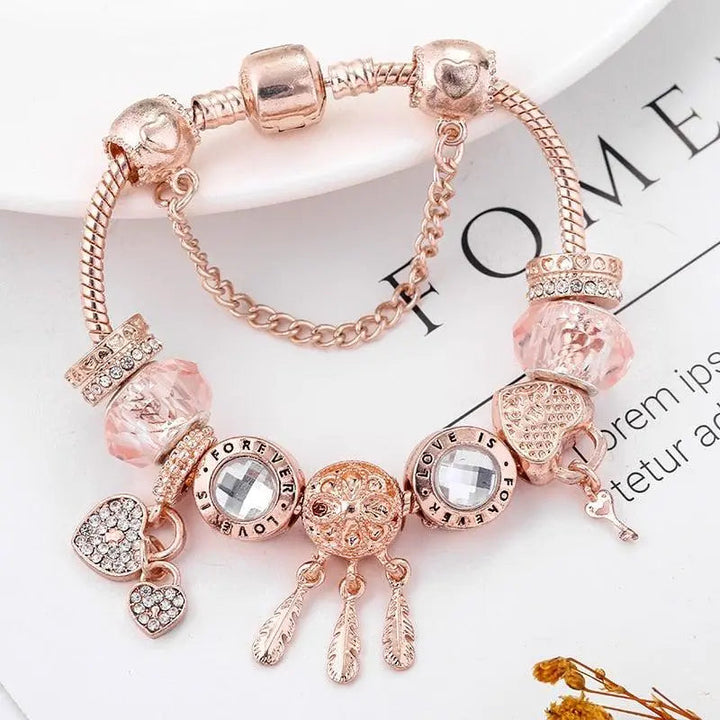 Pink Dream Catcher Bracelet with Silver Charms" can be rewritten as:

"Charming Pink Dream Catcher Bracelet with Silver Accents