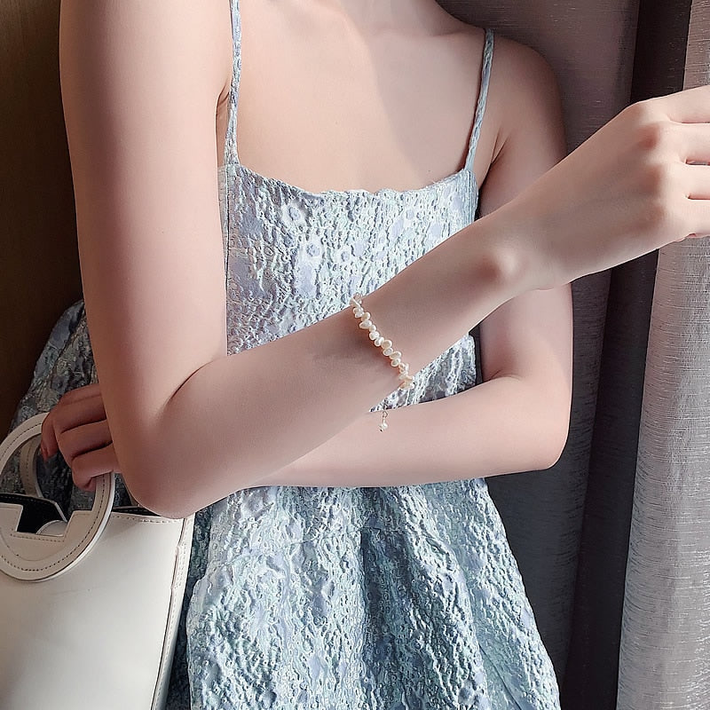 Céline Pearl Bracelet" can be rewritten as "Céline Pearl Charm Bracelet.