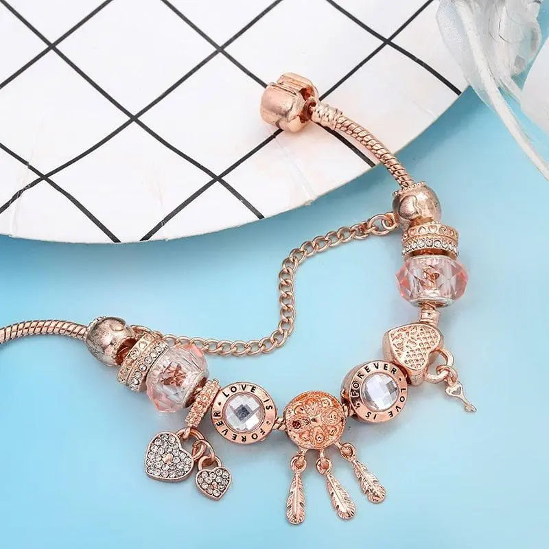 Pink Dream Catcher Bracelet with Silver Charms" can be rewritten as:

"Charming Pink Dream Catcher Bracelet with Silver Accents