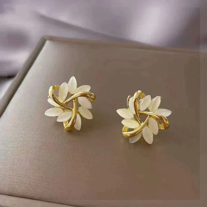 Sonja Luxe White Opal Earrings" can be rewritten as "Sonja Luxe Opal Earrings in White.