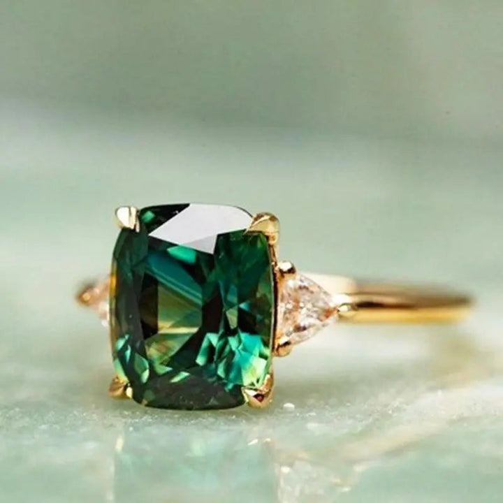 Gold Ring with Green Gemstone" can be rewritten as "Green Gemstone Gold Ring.