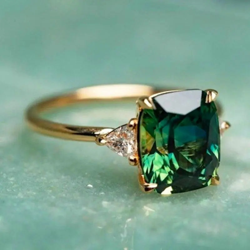 Gold Ring with Green Gemstone" can be rewritten as "Green Gemstone Gold Ring.