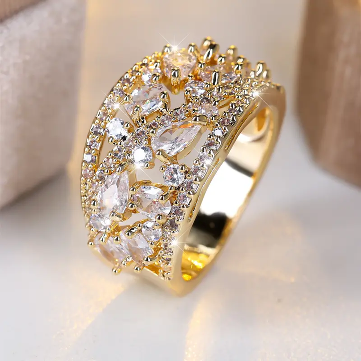 Gold Ring with White Crystals" can be rewritten as "Elegant Gold Ring with Sparkling White Crystals.